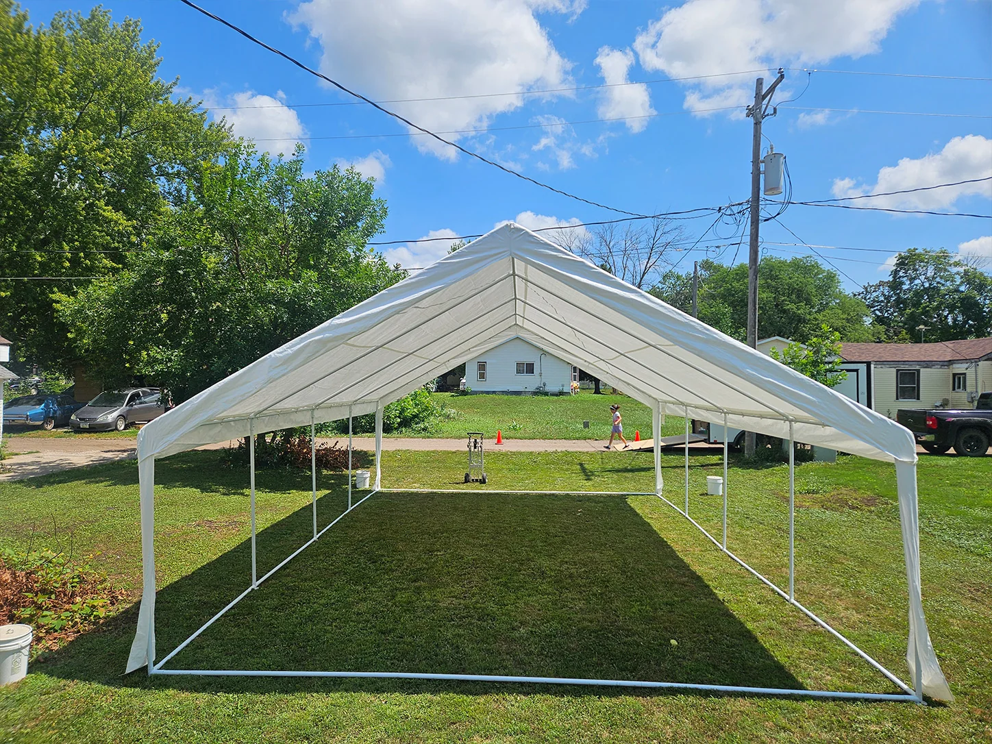 White 20 by 30 event tent installed on a lawn